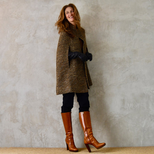 Mid Length Swing Cape in Golden Brown, Black and Camel Boucle from Linton Tweeds. Shown in a winter look. Handmade in Britain.