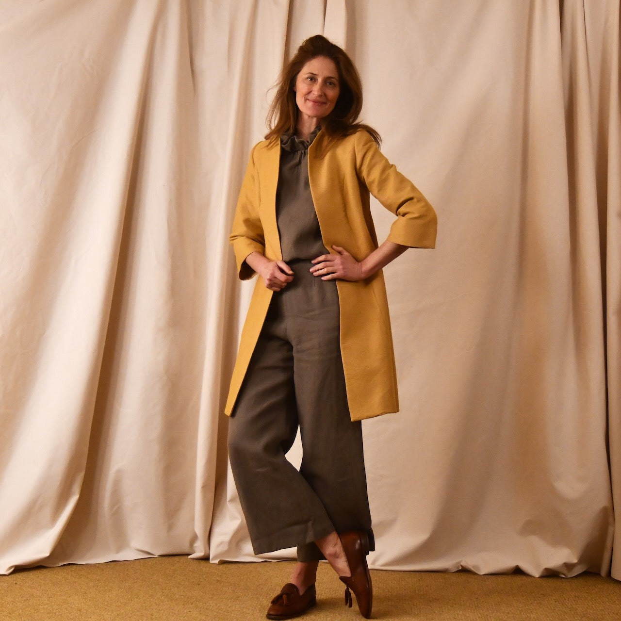 Bespoke Trapeze Swing Coat in Golden Yellow Brocade. Spring Summer MidLength Swing Coat with slight vintage feel and flattering seaming details to front and rear. Shown worn With Trousers