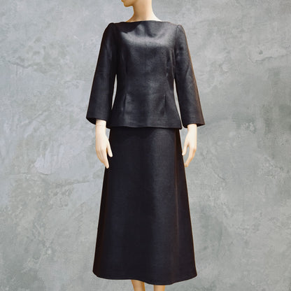 Tailored Summer Skirt Suit in dark navy blue. A boatneck top with a gentle peplum shape sits atop a longer length A-Line skirt. Both fully lined in Silk  and handmade in London. Bespoke skirt suits are also available.