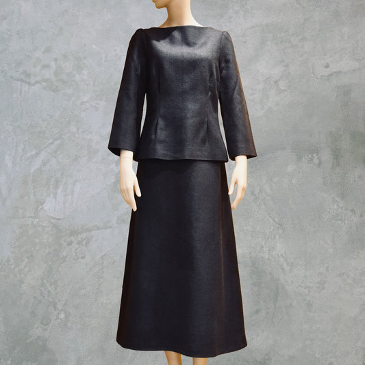 Tailored Summer Skirt Suit in dark navy blue. A boatneck top with a gentle peplum shape sits atop a longer length A-Line skirt. Both fully lined in Silk  and handmade in London. Bespoke skirt suits are also available.