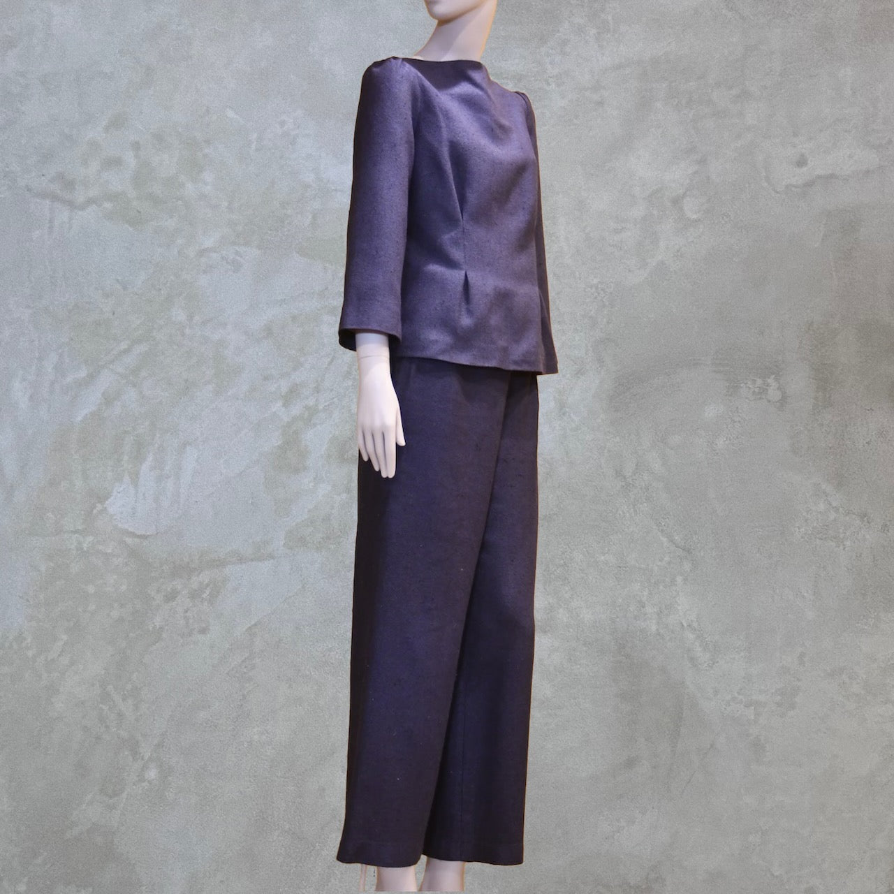 Bespoke Tailored Silk Linen separates featuring a Tailored Boat Neck Blouse in inky blue silk with matching pants. Handmade in Britain. Side on view.