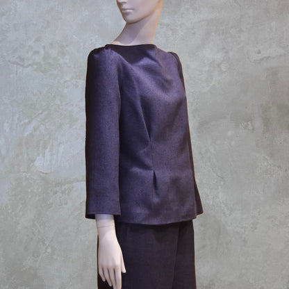 A Tailored Boat Neck Blouse in DarkBlue-Black Silk Matka with a matching skirt, posed sideways. A refined ensemble defined by elegant lines. Handmade in Britain. 