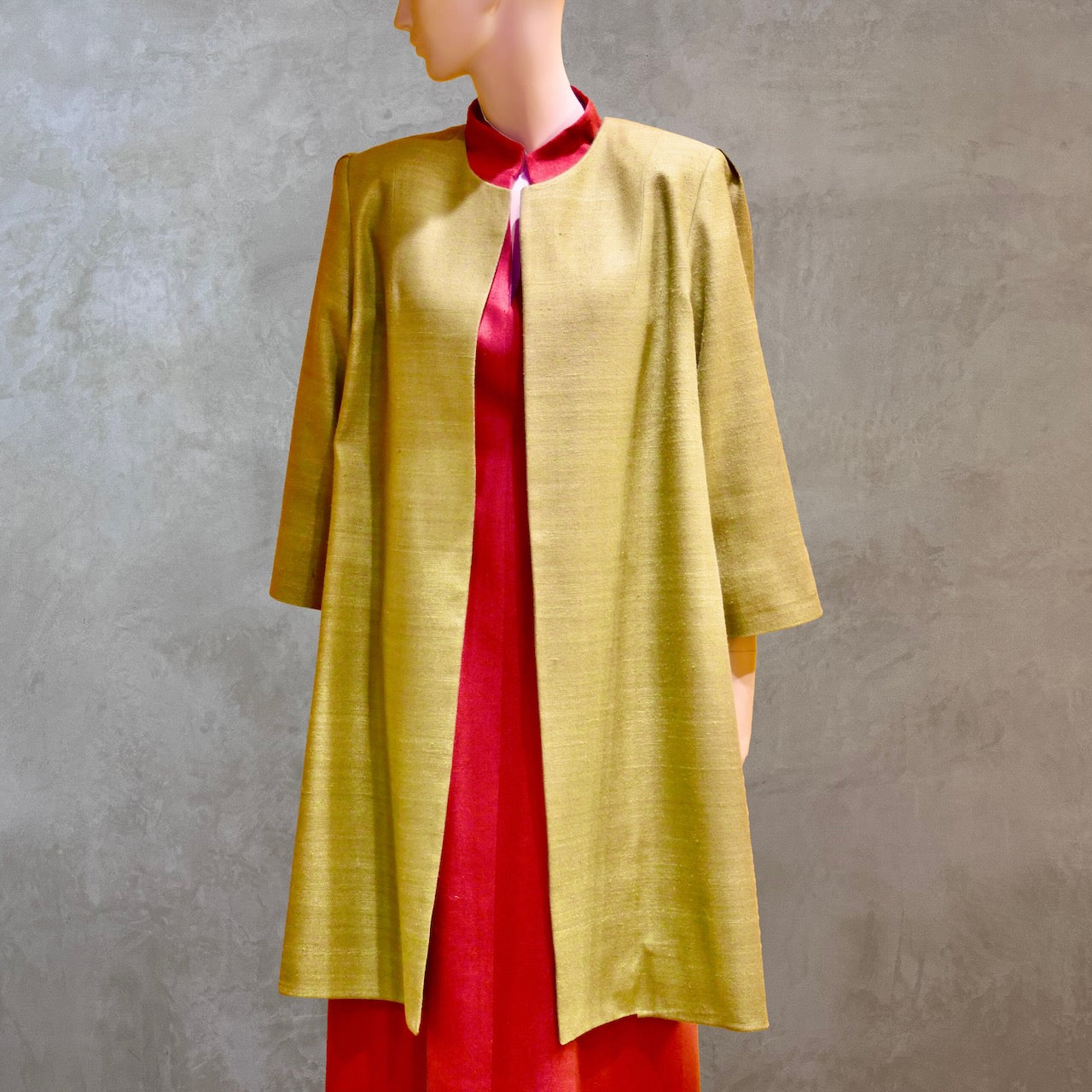 Silk car coat in lime green. This is a Mid length coat with shoulder detail in an easy to wear trapeze shape. Fully lined in silk and made by hand in London.