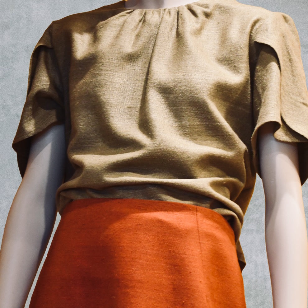 A Khaki tulip-sleeve blouse paired with a terracotta silk skirt. Handmade in Britain.