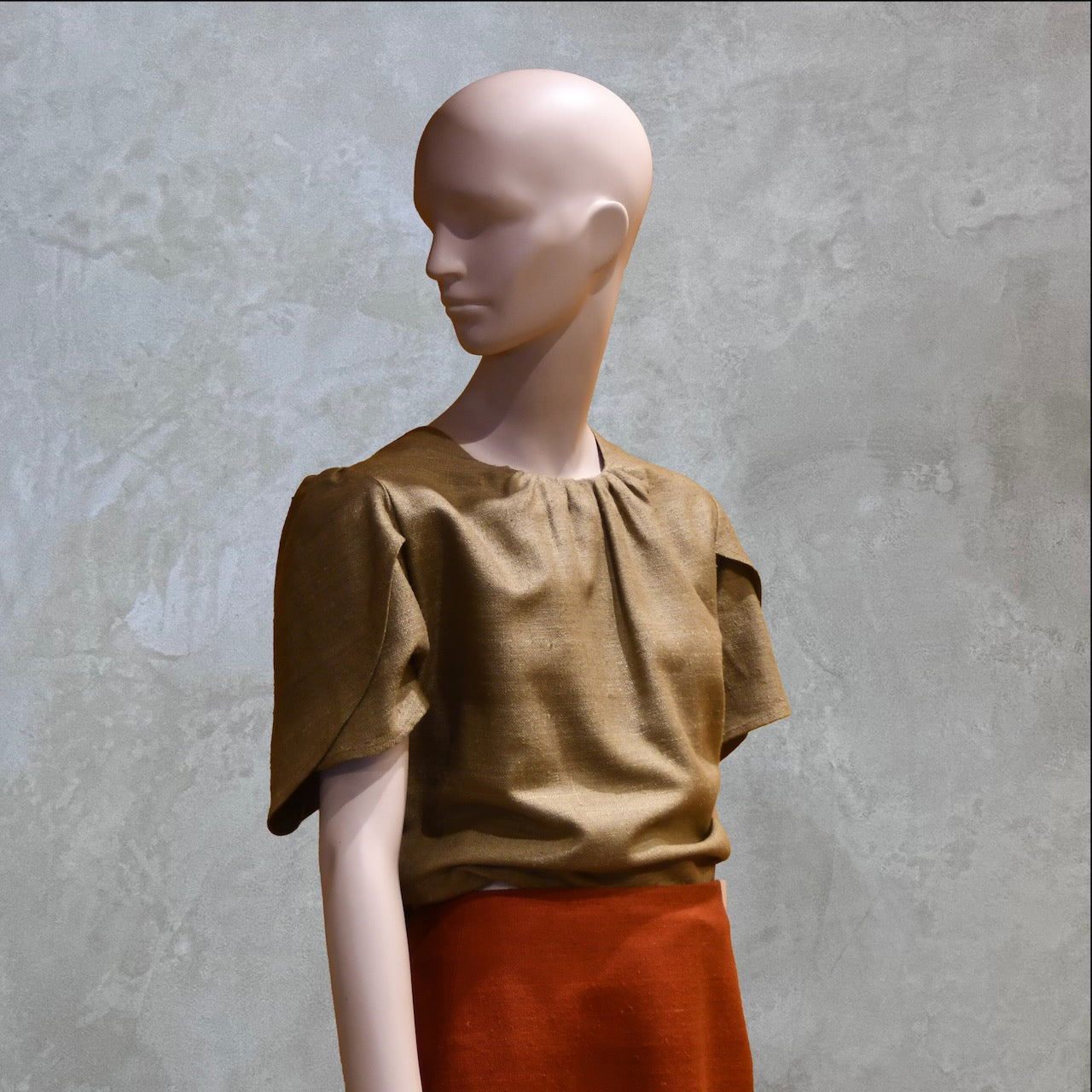 A Tulip Sleeve Blouse in Khaki Silk Matka. Handmade in Britain. Shown with contrast coloured silk skirt.