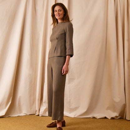 Taupe long-sleeve linen top and matching with taupe linen trousers. The Tailored Boat Neck Blouse is seen from the side view. Handmade in Britain.