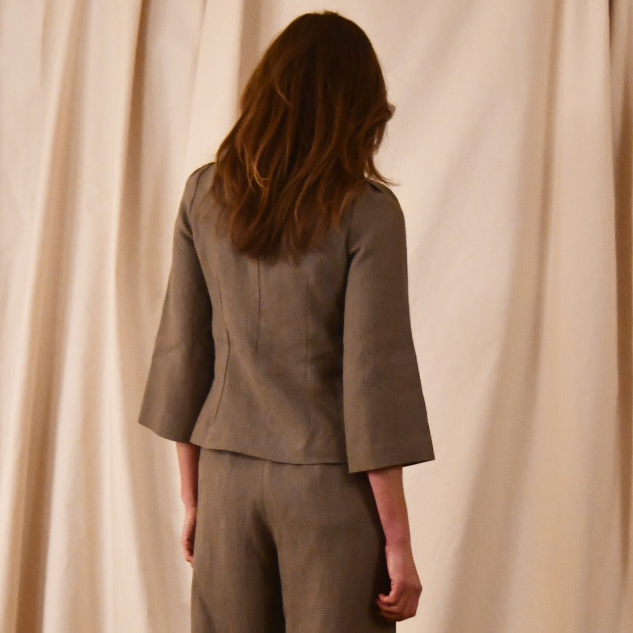 Bespoke Tailored Irish Linen separates featuring a Tailored Boat Neck Blouse in brown linen with matching pants. Handmade in Britain.  Rear View.