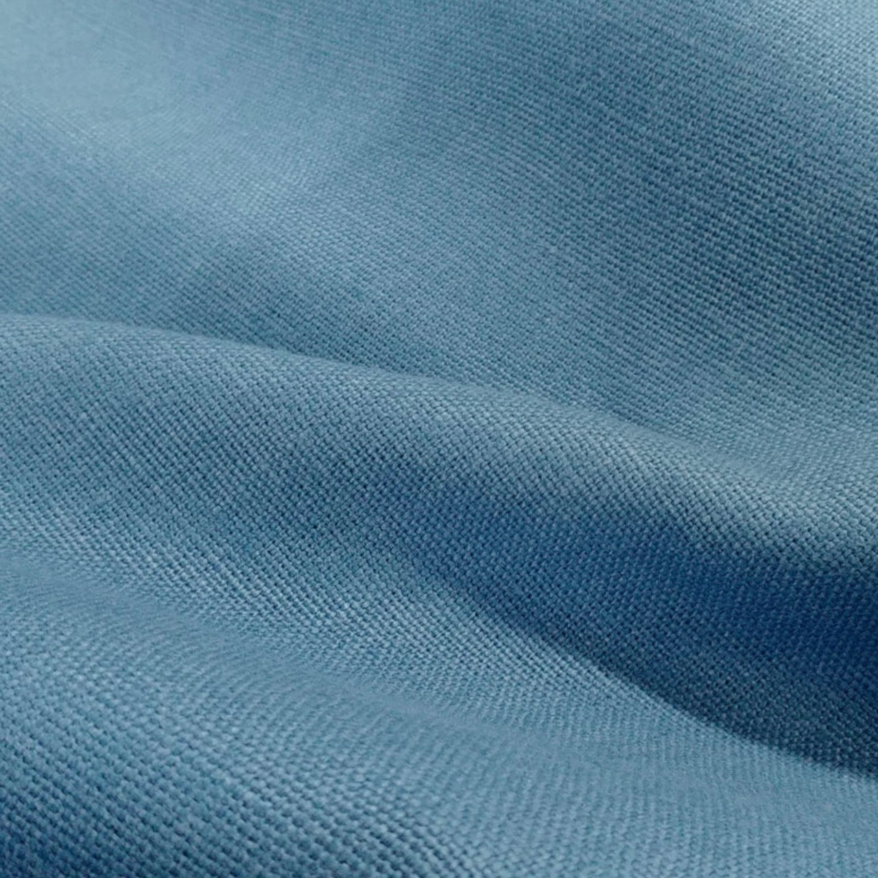 Close-up of the Seafoam Linen fabric used for EdNerat’s Tailored Boat Neck Blouse—light blue weave, soft folds, and gentle shadows make it perfect for breezy summer style. Made by Hand in Great Britain.