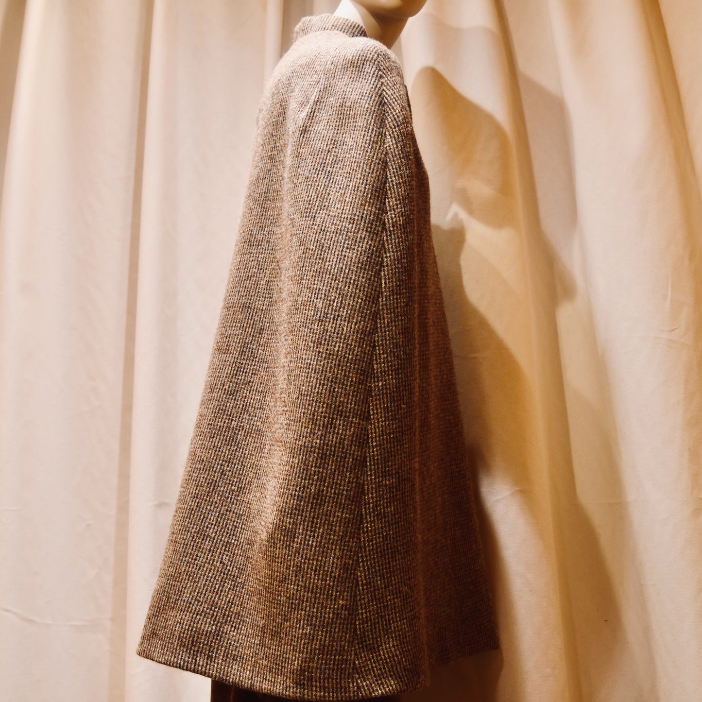 Swing Cape in Small Brown Check Lovat Tweed. Earth-toned texture and elegant style. Handmade in Britain. Back View.