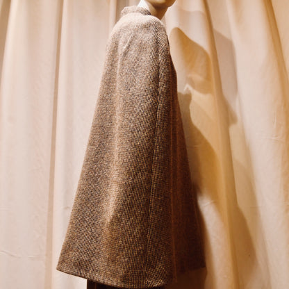 Swing Cape in Small Brown Check Lovat Tweed. Earth-toned texture and elegant style. Handmade in Britain. Back View.