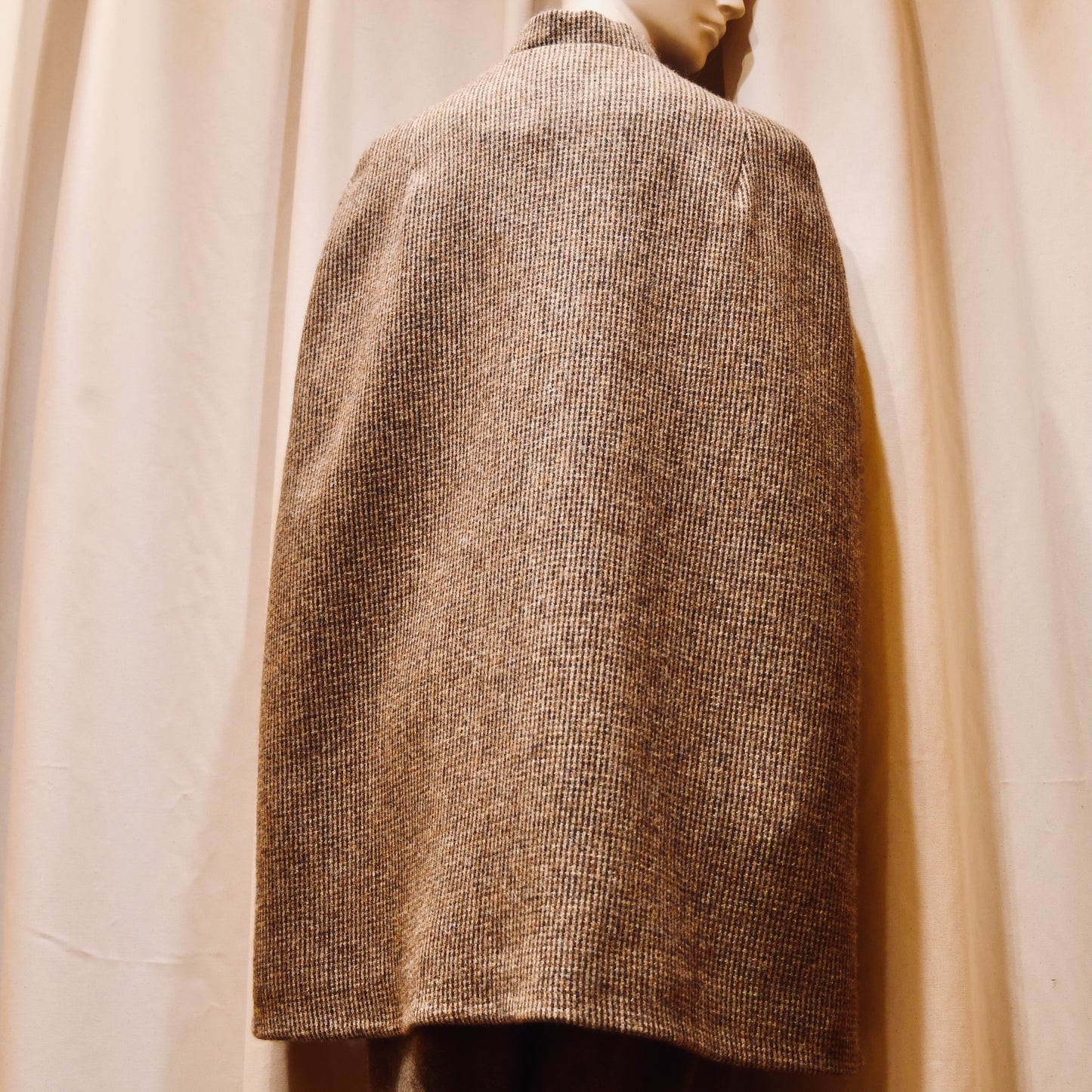 Swing Cape in Small Brown Check Lovat Tweed. Earth-toned texture and elegant style. Handmade in Britain. Back View.