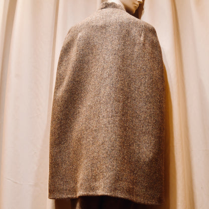 Swing Cape in Small Brown Check Lovat Tweed. Earth-toned texture and elegant style. Handmade in Britain. Back View.