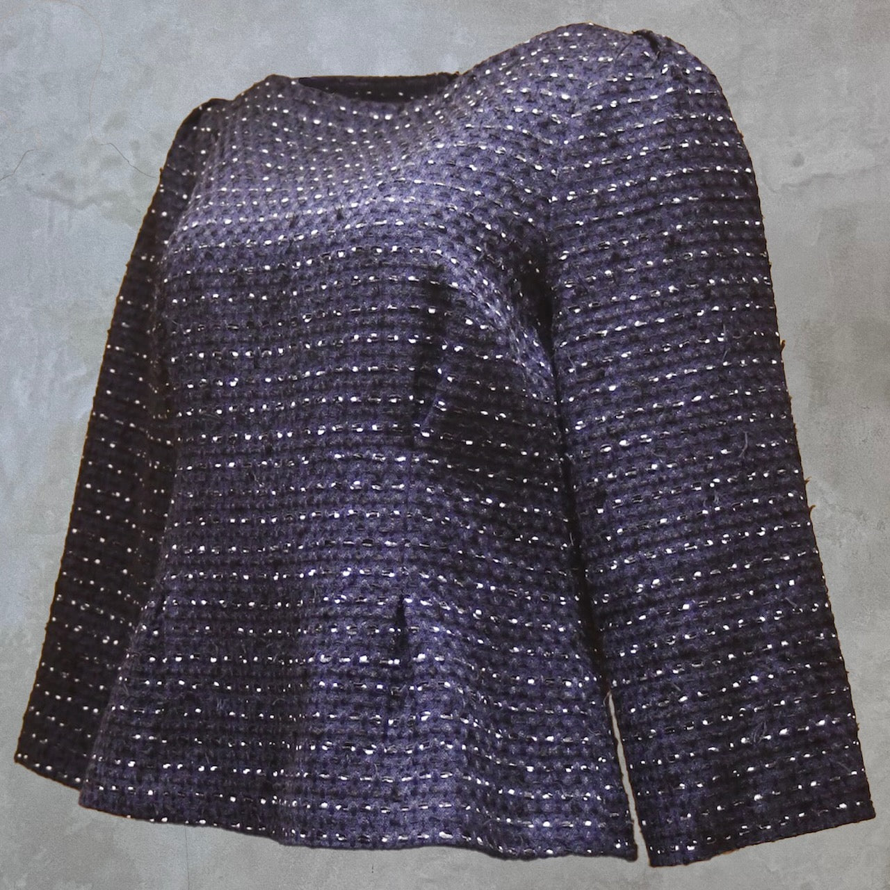 A Tailored Boat Neck Blouse features long sleeves and a grid-textured navy, black, and white cotton boucle. Handmade in Britain.