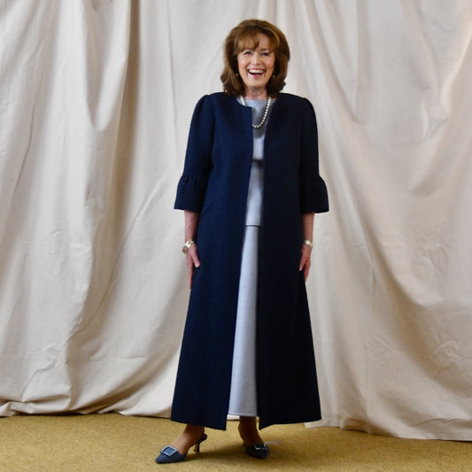 Bespoke Boucle A Line Bell Sleeve Coat. This is a Spring-summer weight coat in a navy cotton boucle from Linton Tweeds. Handmade in Britain. Front View.