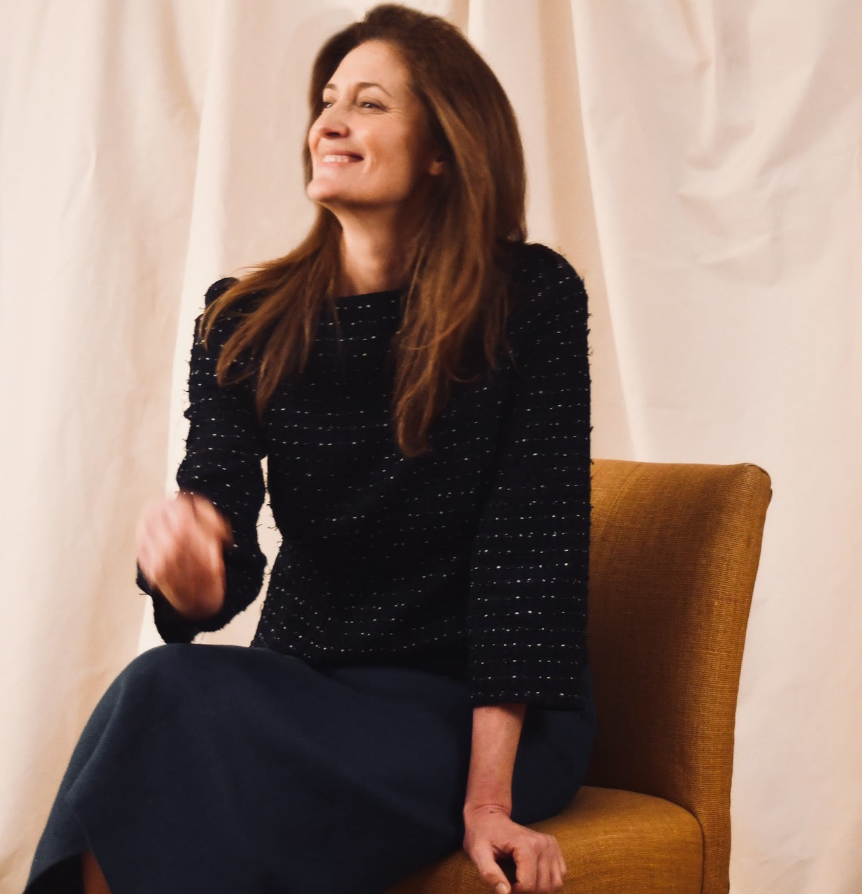 A Tailored Boat Neck Blouse in black cotton boucle and a dark blue skirt. Handmade in Britain.