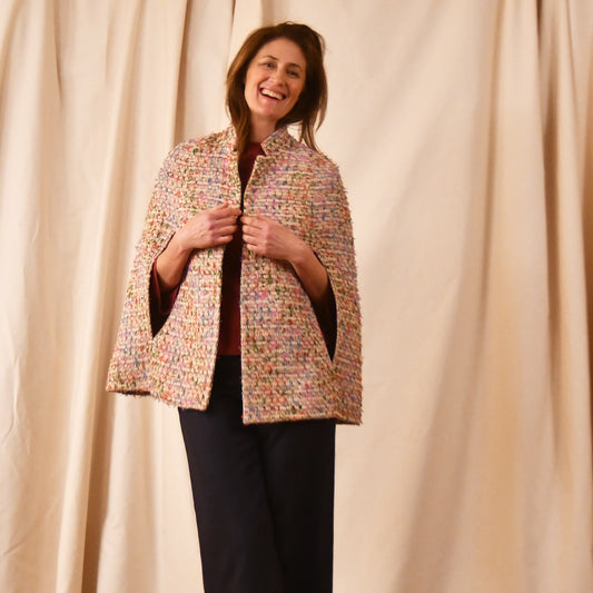 A Vintage Style Swing Cape  in Pale Multicoloured Boucle from Linton Tweeds. Fun, young and elegant. Handmade in Britain. 