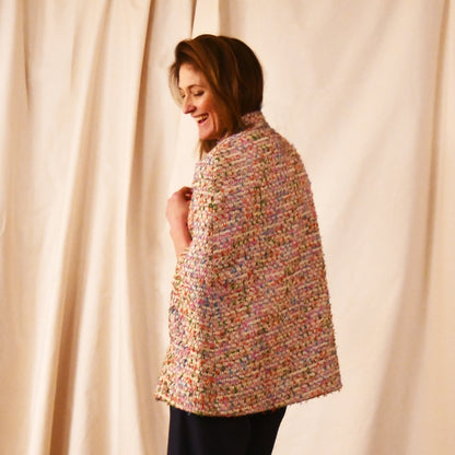 Rear View of A Vintage Style Swing Cape  in Pale Multicoloured Boucle from Linton Tweeds. Fun, young and elegant. Handmade in Britain. 