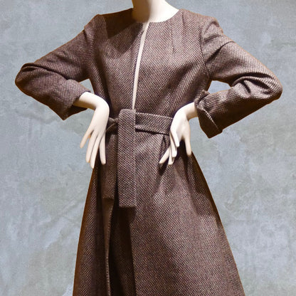 Fitted and tailored hourglass coat in Pink Patterned Tweed over a matching long skirt. Handmade in Britain. Close up on self-fabric belt.