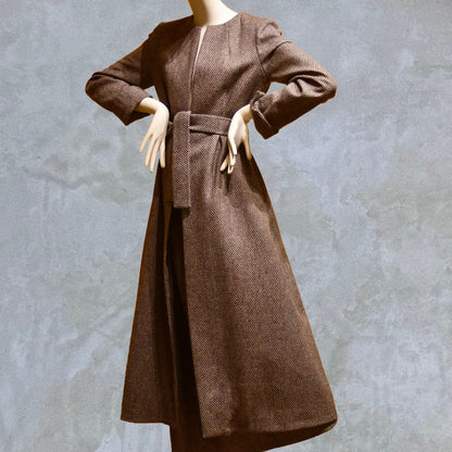 Fitted and tailored hourglass coat in Pink Patterned Tweed over a matching long skirt. Handmade in Britain. Shown Belted.