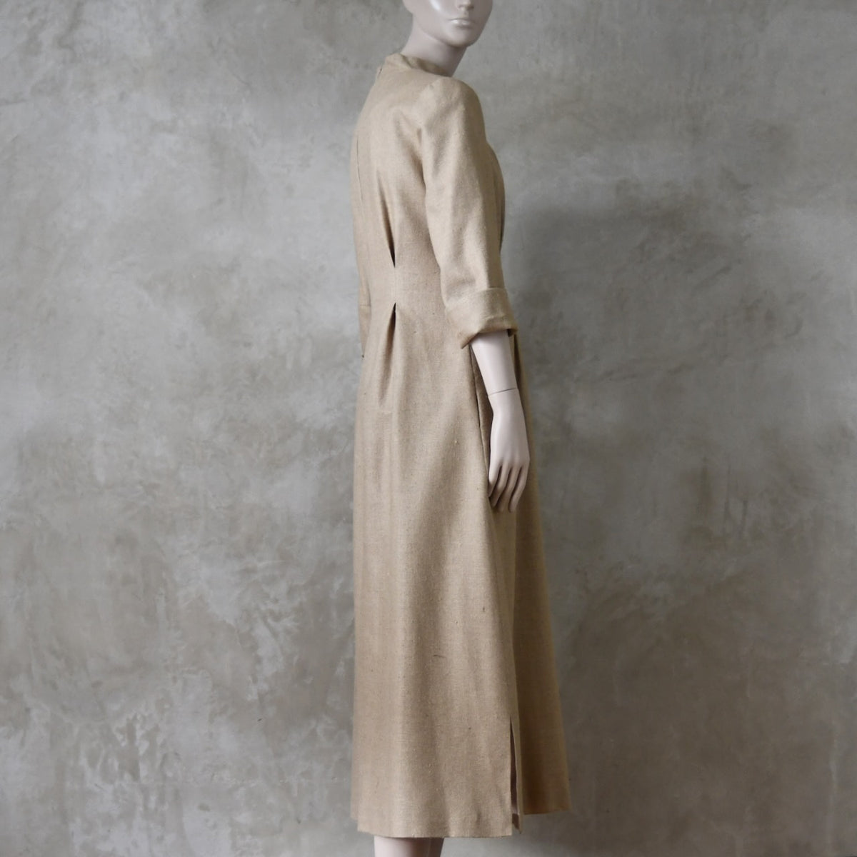 Side view of Cream coloured Waisted longer length  formal mid-season tailored dress. Ready to Ship and Made to order. Sizes 6 to 20 and bespoke. Made by hand in East London.