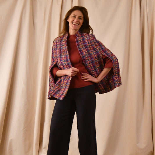 A Vintage Style Swing Cape in Raspberry Boucle from Linton Tweeds. Fun, young and elegant. Handmade in Britain. 