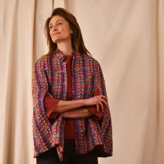 A Vintage Style Swing Cape in Raspberry Boucle from Linton Tweeds. Fun, young and elegant. Handmade in Britain. 