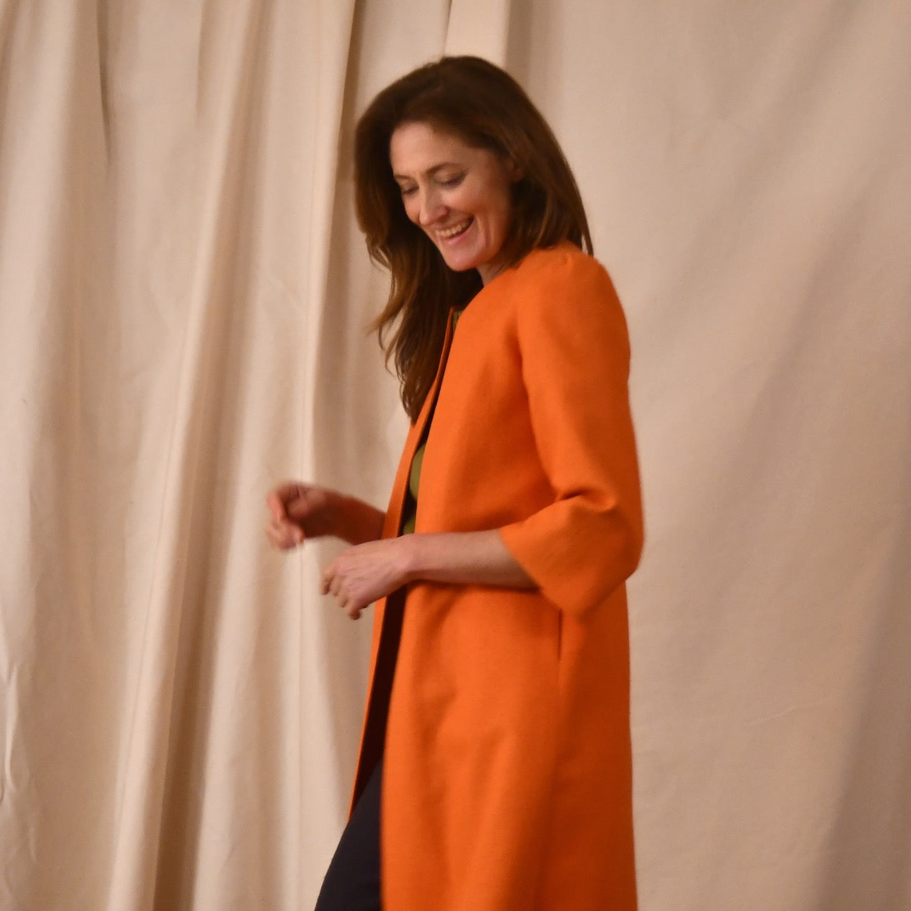 Bespoke Shoulder Detail Trapeze Coat in Silk Matka. This is a Summer Weight Silk Car Coat style shorter length coat available to order in a host of colours. Handmade in Great Britain. Side View of Orange Silk Version.