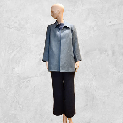 Light Blue Swing Jacket in Irish Linen. Easy and elegant jacket with cuff detail, slant pockets and a wide neck. Handmade in Britain. Full View over Navy Linen Trousers.