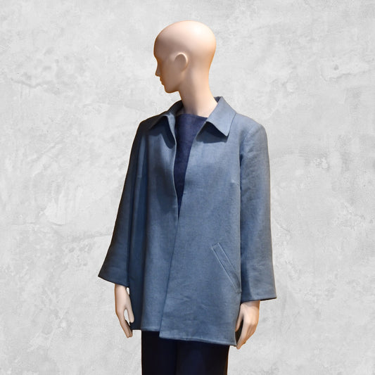 Light Blue Swing Jacket in Irish Linen. Easy and elegant jacket with cuff detail, slant pockets and a wide neck. Handmade in Britain. Off Centre View.