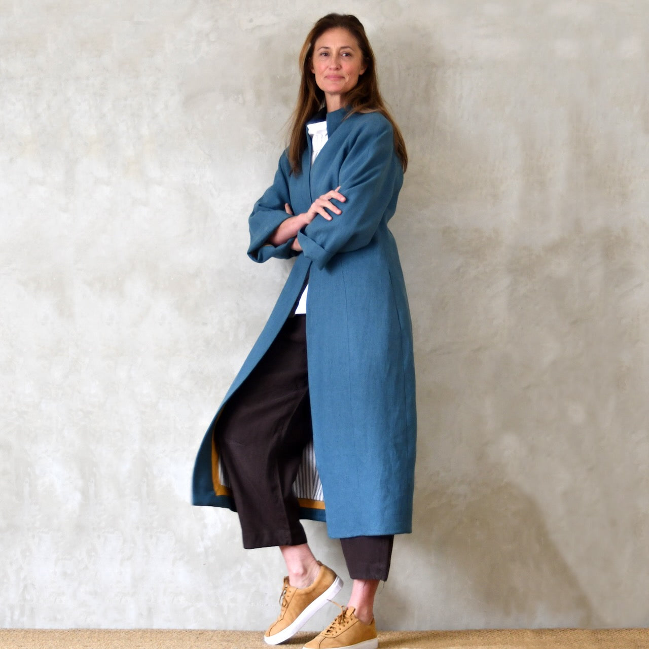 Longer Length Cocoon Coat in Blue Irish Linen. An easy to wear Spring-summer coat in a delightfully flattering cocoon shape. An investment piece to last across the years. Handmade in Britain. Side View.