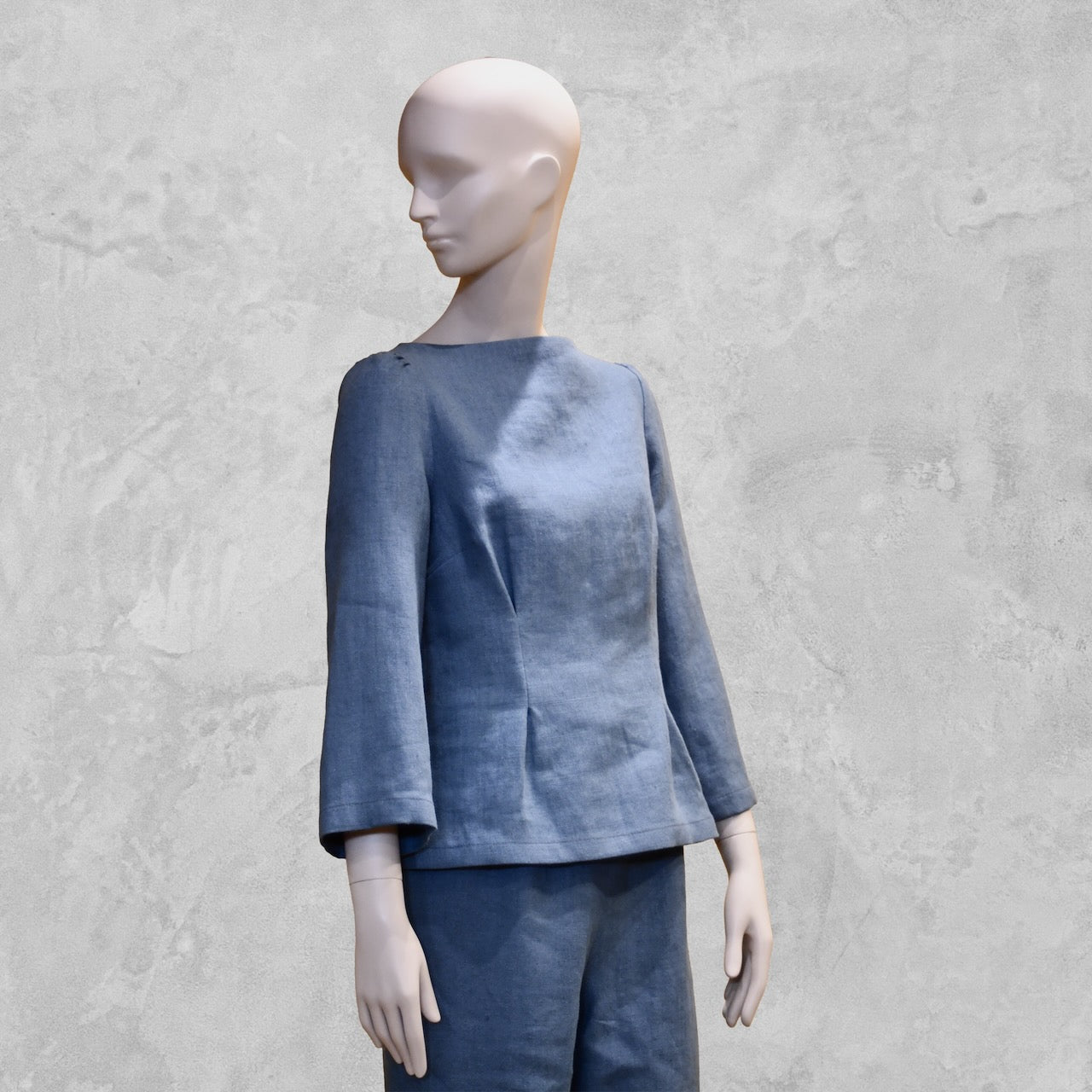 Bespoke Sea Blue Boat Neck Tailored Top  with three quarter sleeves in Slubby Irish Linen. Shown worn over matching seafoam linen trousers, close up.
Handmade in Britain.