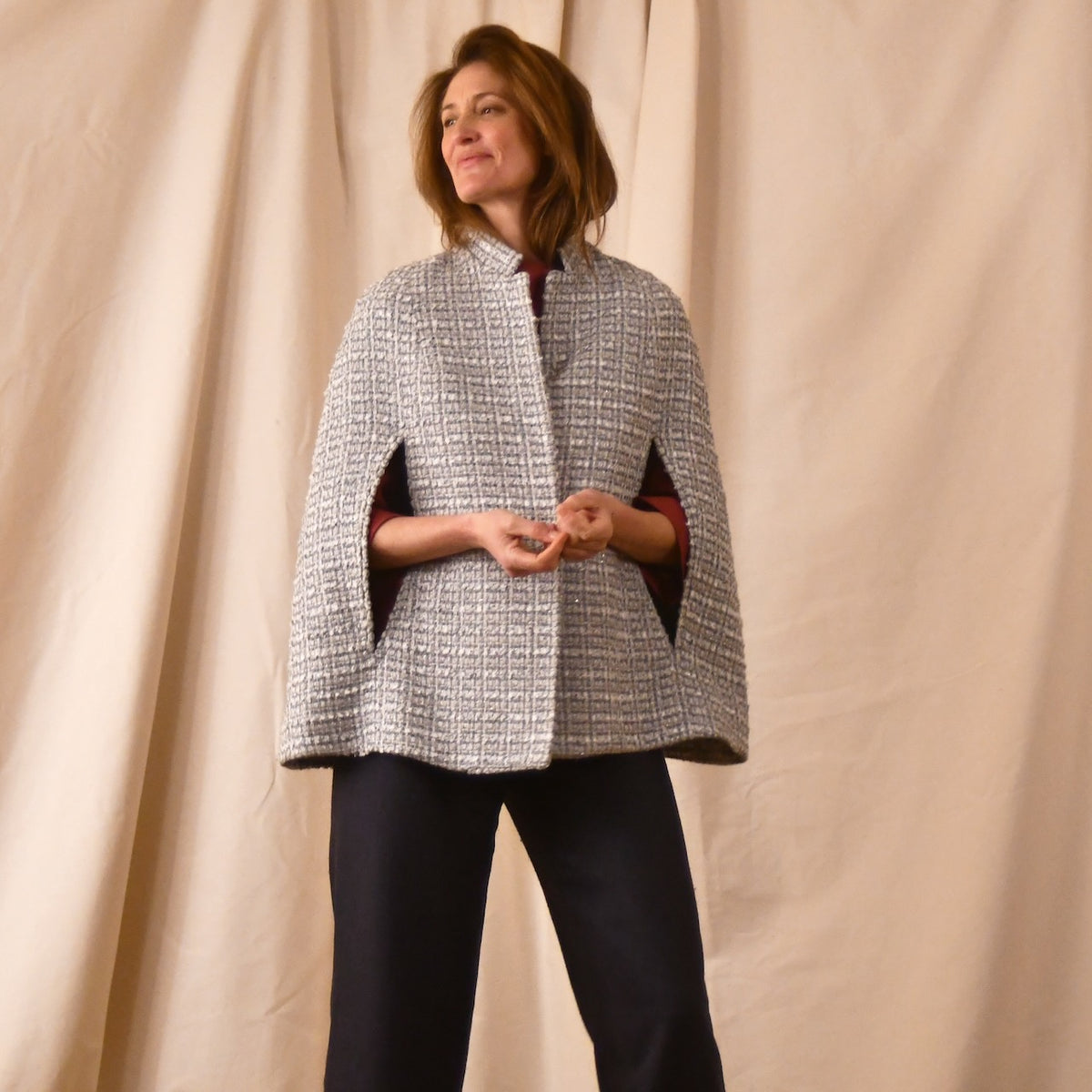 A swing Cape in Silver Mix Boucle from Linton Tweeds in an elegant fun, youthful look. Handmade in Britain.