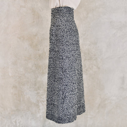 A Waisted A-Line Skirt in Linton Tweeds Boucle, a high-waisted, ankle-length black and white piece. Handmade in Britain.
