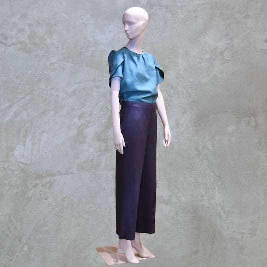 A Tulip Sleeve Blouse in Emerald Silk Matka. Handmade in Britain. Shown paired with bespoke inky blue silk trousers.