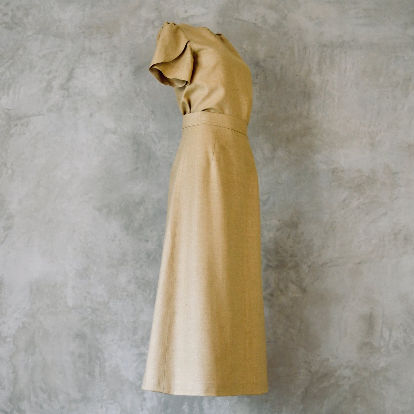 A Waisted Silk Summer A-Line Skirt in a pale coloured wheat. Featuring a fitted waist and simple, elegant design. Handmade in Britain. Shown with a matching Tulip-Sleeved Blouse.