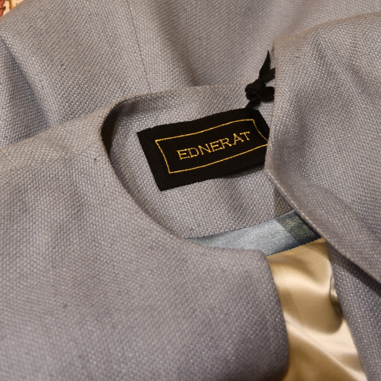 Neck Detail of Fitted Coat with nipped in waist executed in a delightful pure silk silk matka weave. Handmade in London this longer length coat is perfect for weddings and formal summer occasions.