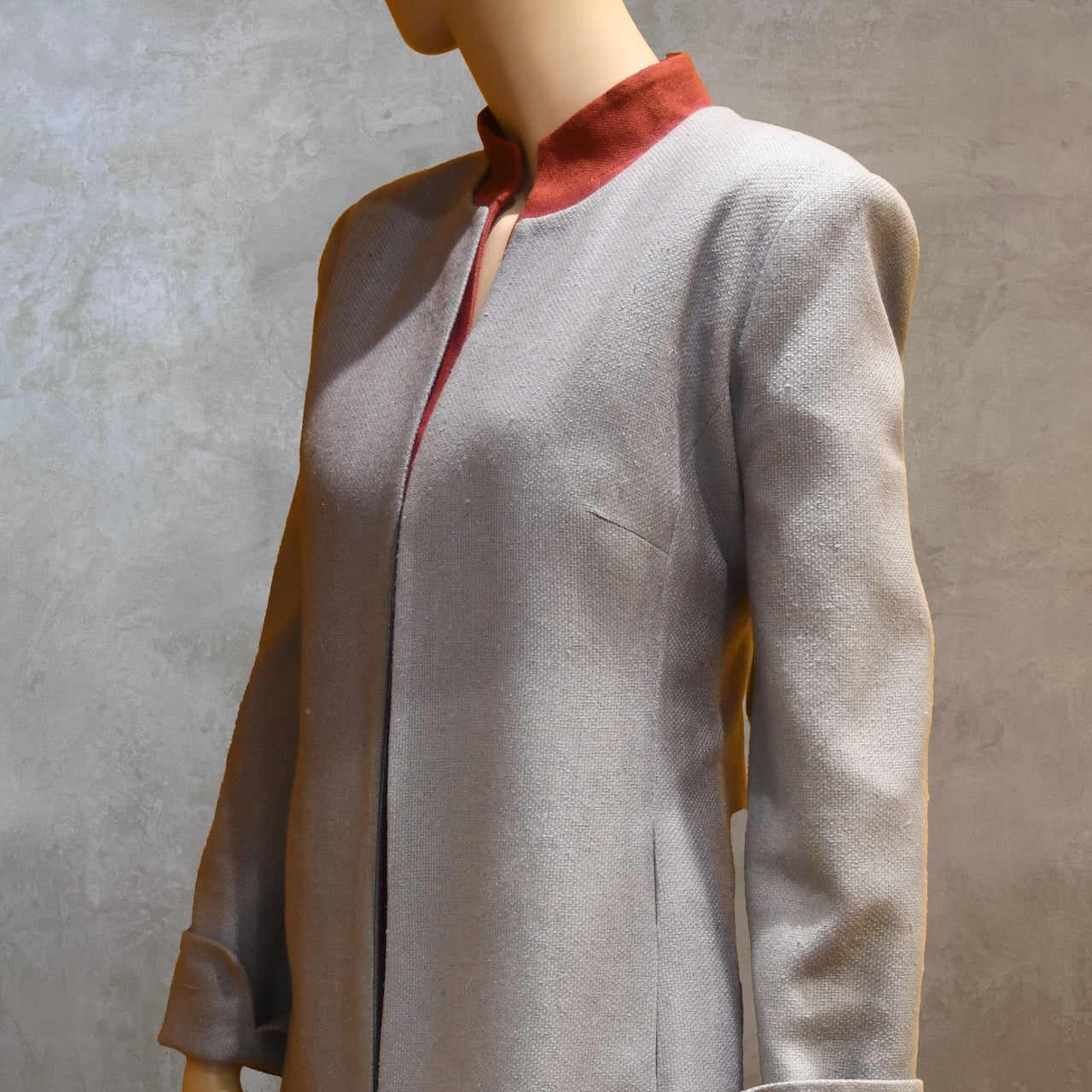 Shoulder view of Fitted Coat with nipped in waist executed in a delightful pure silk silk matka weave. Handmade in London this longer length coat is perfect for weddings and formal summer occasions.