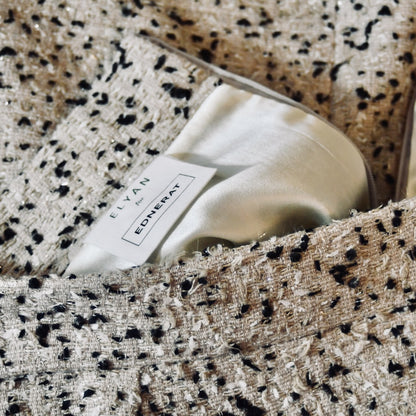 Bespoke Tailored Hourglass-Shaped Coat in Camel, Black and White Flag Textured Bouclé, from Linton Tweeds. A Collar-less shaped coat for weddings and formal occasions. Handmade in Britain. Skirt Detail.