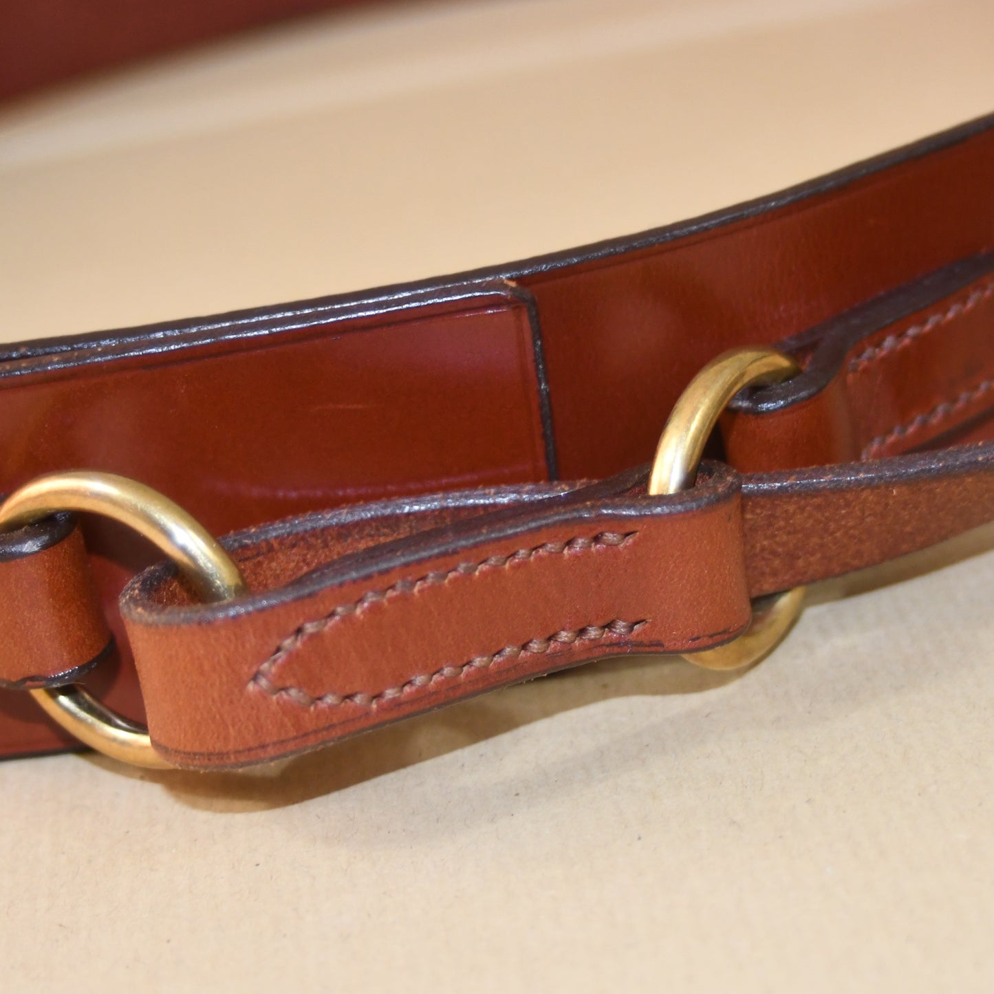 Close-up of the EDNERAT Hazel Ring Wrap Belt - 68cm, crafted from British saddle leather with solid brass fittings and detailed stitching. Handmade in Britain.