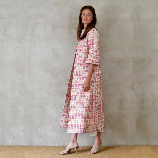 Bell Sleeve A-Line Coat in Pink Patterned Linton Tweeds Boucle. A pretty, longer length A-line coat in a pink, cream and gold check pattern for smart spring and summer occasions. Entirely made in Great Britain.