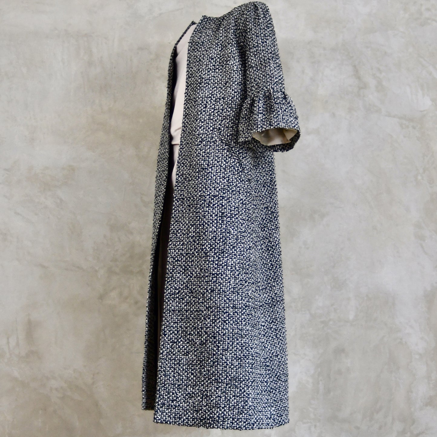 A Longer length Bell Sleeve A-Line Coat in Black and OffWhite Linton Tweeds Boucle
This is an elegant longer length A-Line coat in a patterned boucle from Carlisle. With a magnificent drape and delicate sleeve and shoulder detailing, this coat will take you everywhere. Handmade in Britain.