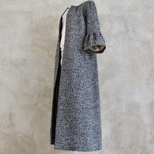A Longer length Bell Sleeve A-Line Coat in Black and OffWhite Linton Tweeds Boucle
This is an elegant longer length A-Line coat in a patterned boucle from Carlisle. With a magnificent drape and delicate sleeve and shoulder detailing, this coat will take you everywhere. Handmade in Britain.