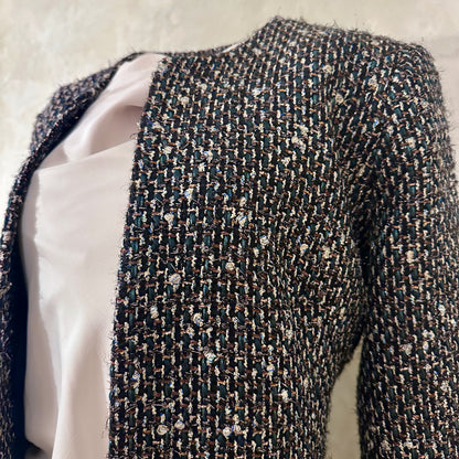 Tailored Hourglass Coat in Metallic Linton Tweeds Boucle. A Longer Length Fitted Bouclé Coat perfect for Evening Wear. An investment piece in the opera coat tradition.
Handmade in Britain. Fabric Close Up.