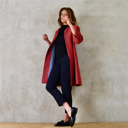 Trapeze Swing Coat in Limited Edition Rust Corn Brocade. A bespoke  Elegant Spring or Work MidLength Swing Coat with slight vintage feel and flattering seaming details to front and rear. Entirely made in Great Britain. Motion View showing sumptuous blue silk lining.