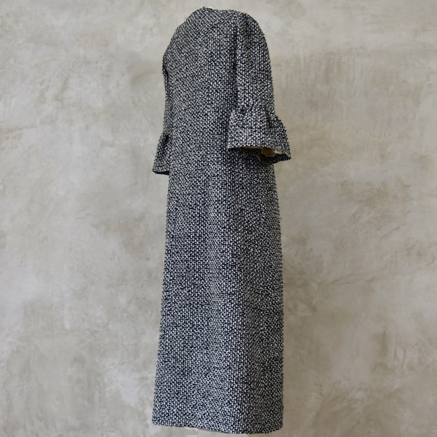 A Longer length Bell Sleeve A-Line Coat in Black and OffWhite Linton Tweeds Boucle
This is an elegant longer length A-Line coat in a patterned boucle from Carlisle. With a magnificent drape and delicate sleeve and shoulder detailing, this coat will take you everywhere. Handmade in Britain.