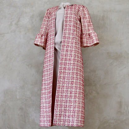 Bell Sleeve A-Line Coat in Pink Patterned Linton Tweeds Boucle. A pretty, longer length A-line coat in a pink, cream and gold check pattern for smart spring and summer occasions. Entirely made in Great Britain. Side On View.