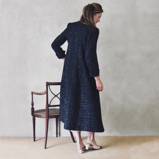Tailored and Fitted Hourglass Coat in Dark Navy Boucle from Linton Tweeds. This investment piece has long sleeves and hidden pockets. Handmade in Britain. Side View